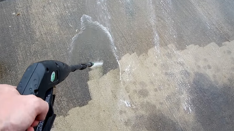 Rinse oil stains from concrete