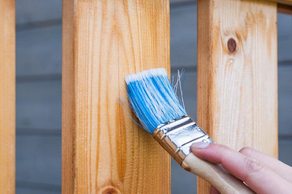 Applying paint from the brush on furniture